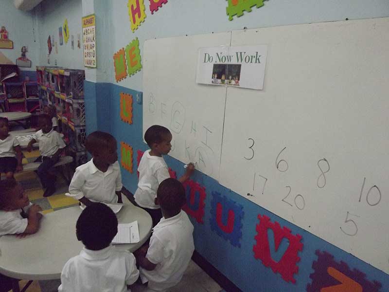 Pre School students working on letters and numbers.